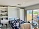 Bedroom featuring a floral print bedspread and built-in shelving with outdoor views at 100 Bluff View Dr # 105C, Belleair Bluffs, FL 33770