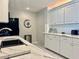 Bright kitchen with white cabinets, tile backsplash, and stainless steel appliances at 100 Bluff View Dr # 105C, Belleair Bluffs, FL 33770