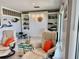 Comfortable living room with tile flooring, a built in wall unit, and recliner chairs at 100 Bluff View Dr # 105C, Belleair Bluffs, FL 33770