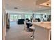 Bright living room with glass doors to the balcony, a bar with seating, and a mirrored wall at 100 Bluff View Dr # 105C, Belleair Bluffs, FL 33770