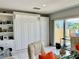 Comfortable living room with tile flooring, a built in wall unit, and recliner chairs with balcony access at 100 Bluff View Dr # 105C, Belleair Bluffs, FL 33770