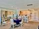 Inviting dining area with bar, open to a well-lit kitchen with white cabinets at 100 Bluff View Dr # 105C, Belleair Bluffs, FL 33770
