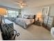 Comfortable main bedroom with a ceiling fan and an array of dressers and decorations at 100 Bluff View Dr # 105C, Belleair Bluffs, FL 33770