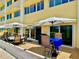 Patio featuring outdoor furniture and shade umbrellas at 100 Bluff View Dr # 105C, Belleair Bluffs, FL 33770