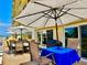Patio featuring outdoor furniture and shade umbrellas at 100 Bluff View Dr # 105C, Belleair Bluffs, FL 33770