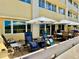 Patio featuring outdoor furniture and shade umbrellas at 100 Bluff View Dr # 105C, Belleair Bluffs, FL 33770