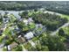 Aerial view of waterfront homes along river with docks, boat ramp, park, and lush green landscape at 10922 Park Dr, Riverview, FL 33569