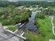 Aerial view of the community boat ramp on a river bend surrounded by green trees and grass at 10922 Park Dr, Riverview, FL 33569