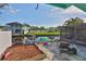 A tranquil waterfront view from the backyard featuring a patio and lush greenery at 10922 Park Dr, Riverview, FL 33569