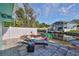 Backyard patio with a lounge chair and waterfront view overlooking a serene canal at 10922 Park Dr, Riverview, FL 33569