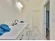 Stylish bathroom offers a white vanity with black hardware and marble-look tile flooring at 10922 Park Dr, Riverview, FL 33569
