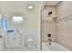 Bright bathroom with a tub, shower, modern vanity, and stylish tile work at 10922 Park Dr, Riverview, FL 33569
