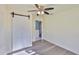 Bright bedroom with modern lighting, wood floors, and a sliding closet door at 10922 Park Dr, Riverview, FL 33569