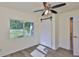 Bright bedroom featuring wood floors, a ceiling fan, and a sliding closet door at 10922 Park Dr, Riverview, FL 33569