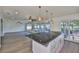 Kitchen features a large island with cooktop, pendant lighting, and stainless steel appliances with access to the deck at 10922 Park Dr, Riverview, FL 33569