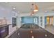 A kitchen with stainless appliances, granite countertops, a large island with a cooktop, and pendant lighting at 10922 Park Dr, Riverview, FL 33569