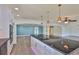 The kitchen boasts a central island with a built-in cooktop, black granite countertops, and stainless steel appliances at 10922 Park Dr, Riverview, FL 33569