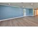 A bright living room with pale blue walls, white trim, and neutral-toned wood-look flooring at 10922 Park Dr, Riverview, FL 33569