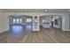 Spacious, open-concept living room with a view of a modern kitchen and lots of light from the porch at 10922 Park Dr, Riverview, FL 33569