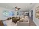 Bright living room with hardwood floors and open access to the kitchen and dining area at 10922 Park Dr, Riverview, FL 33569