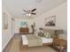 Comfortable main bedroom features modern ceiling fan, light walls, and wood-look flooring at 10922 Park Dr, Riverview, FL 33569