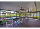 Inviting screened porch with comfortable rocking chairs, offering a serene waterfront view at 10922 Park Dr, Riverview, FL 33569