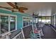 Comfortable screened porch featuring waterfront views and multiple ceiling fans to keep you cool at 10922 Park Dr, Riverview, FL 33569