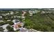 Wide aerial view of the neighborhood showing houses, trees, a pond, and green spaces in the community at 11021 Silver Dancer Dr, Riverview, FL 33579