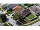 Aerial view of the house showing the roof, the fenced backyard, landscaping, and neighborhood streets at 11021 Silver Dancer Dr, Riverview, FL 33579