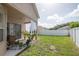 The outdoor patio has seating and curtains with a view to a fenced backyard at 11021 Silver Dancer Dr, Riverview, FL 33579