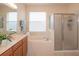 Bright bathroom with garden tub, glass shower and white tile backsplash at 11021 Silver Dancer Dr, Riverview, FL 33579