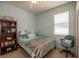 This bedroom has blue walls, a ceiling fan, a wooden bookshelf and chair at 11021 Silver Dancer Dr, Riverview, FL 33579