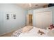 This bedroom is painted blue and has white trim and a large closet at 11021 Silver Dancer Dr, Riverview, FL 33579