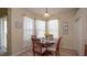 Bright dining area with natural light, wood table and chairs, sheer curtains at 11021 Silver Dancer Dr, Riverview, FL 33579