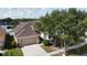 Inviting single-Gathering home with a well-manicured lawn, mature trees, and attached two-car garage at 11021 Silver Dancer Dr, Riverview, FL 33579