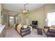 Bright living room with comfortable seating, a ceiling fan, and a neutral color palette at 11021 Silver Dancer Dr, Riverview, FL 33579