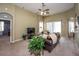 Cozy living room featuring comfortable seating, a ceiling fan, and neutral color scheme at 11021 Silver Dancer Dr, Riverview, FL 33579