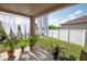 Covered patio features plants and white sheer curtains at 11021 Silver Dancer Dr, Riverview, FL 33579