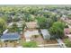 Aerial view of a home with mature trees, a fenced-in yard, and a shed at 11315 N Armenia Ave, Tampa, FL 33612