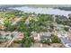 Aerial view of a house in a lush, green neighborhood near a lake at 11315 N Armenia Ave, Tampa, FL 33612