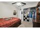 This carpeted bedroom features a ceiling fan, closet and Florida State Seminoles bedding at 11315 N Armenia Ave, Tampa, FL 33612