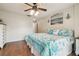 Comfortable bedroom featuring wood floors, ceiling fan, and bright natural light at 11315 N Armenia Ave, Tampa, FL 33612