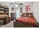 A well-appointed bedroom with a ceiling fan and decor showcasing loyalty to the Florida State Seminoles at 11315 N Armenia Ave, Tampa, FL 33612