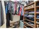 Organized walk-in closet with hanging clothes, shelves, and shoe racks for ample storage at 11315 N Armenia Ave, Tampa, FL 33612
