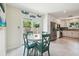 Dining area with a modern table set, tile floors, and natural light from a sliding glass door at 11315 N Armenia Ave, Tampa, FL 33612