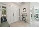 Bright entryway features a modern console table, tile floors, and a double-door entry at 11315 N Armenia Ave, Tampa, FL 33612