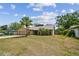 Charming single-Gathering home featuring a front yard, mature palm tree, and attached two-car garage at 11315 N Armenia Ave, Tampa, FL 33612