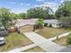 Charming single-story home with a large driveway and well-maintained lawn and landscaping at 11315 N Armenia Ave, Tampa, FL 33612