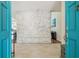 Bright foyer view featuring stone accent wall, hardwood flooring and front door at 11315 N Armenia Ave, Tampa, FL 33612