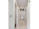 This light-filled hallway features wood-look floors and mirrored closet doors at 11315 N Armenia Ave, Tampa, FL 33612